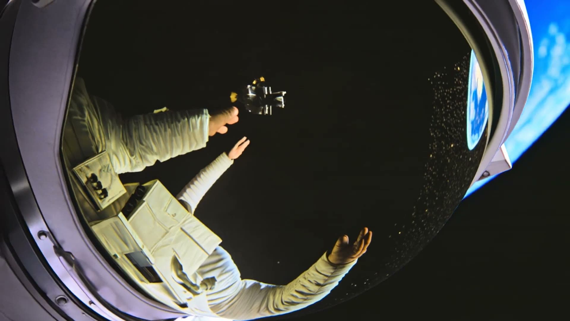 An astronaut reaching toward a giant glowing golden hand in space